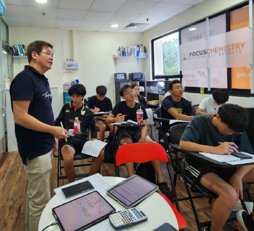 Tutor Dion Khoo with a small-scale sized class of Chemistry students