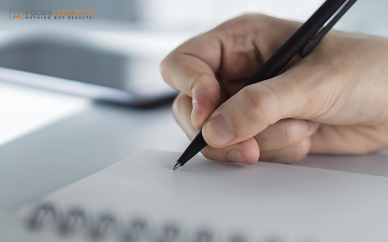 Student using a pen to practice effective note-taking strategies.